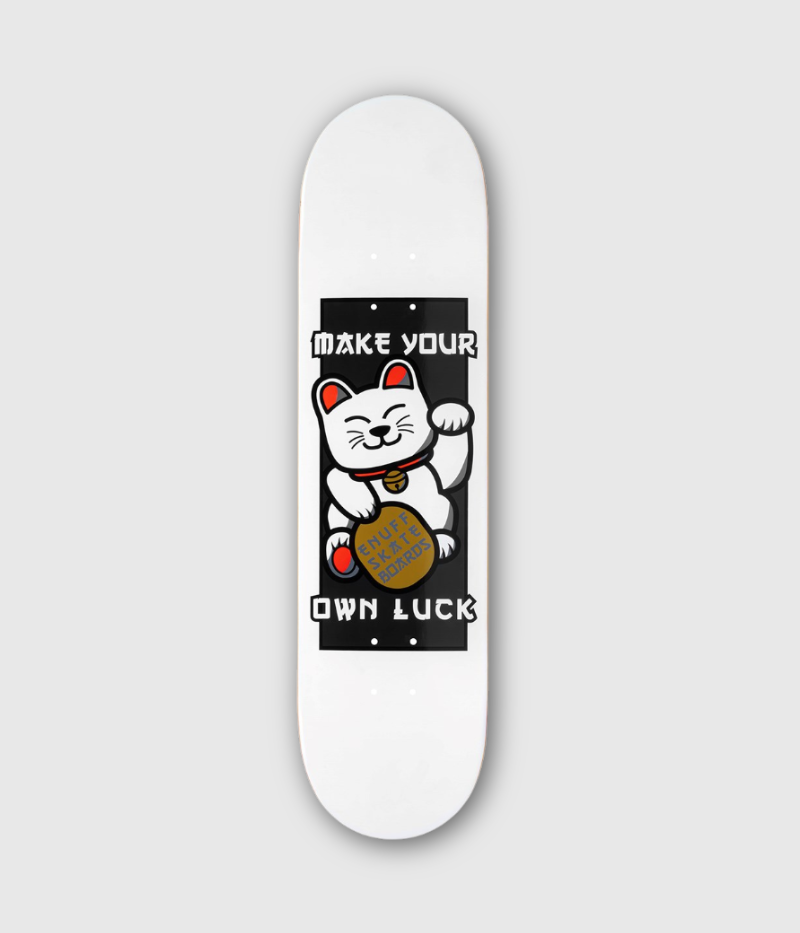 A white skateboard deck featuring a graphic of a white cat with red ears and a gold bell, holding a gold coin, with the text 'MAKE YOUR OWN LUCK' in white on a black rectangular background.