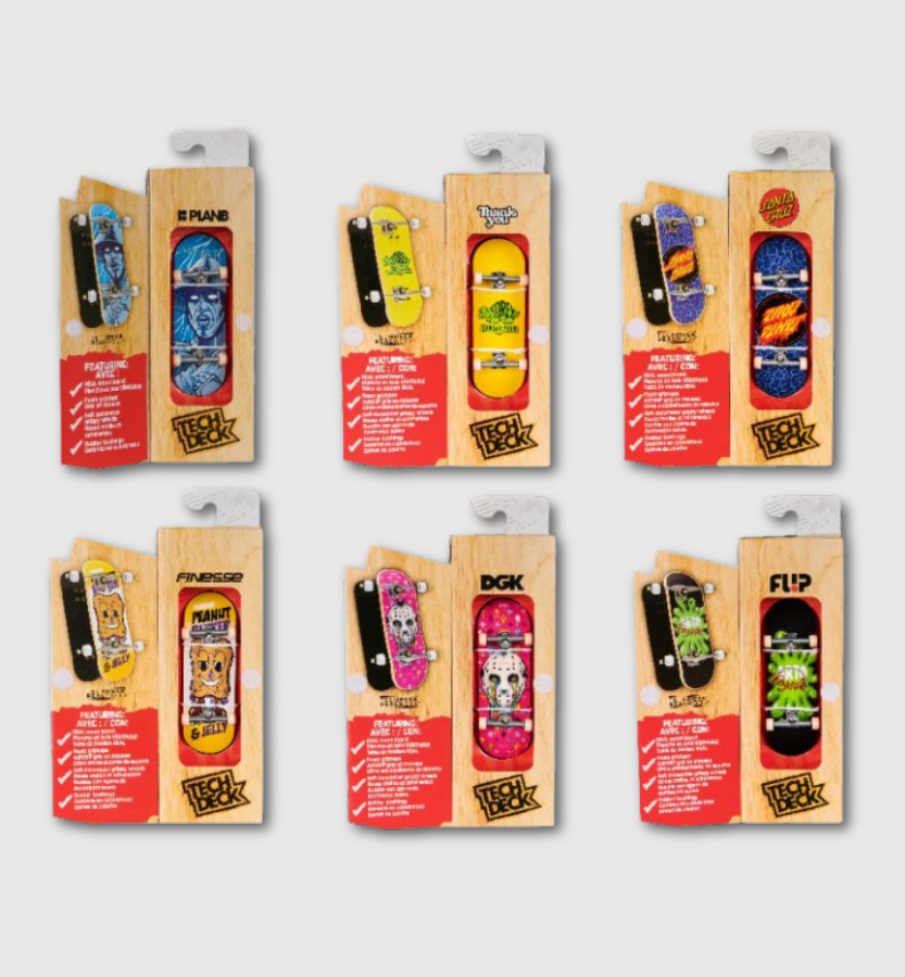 Six packaged miniature skateboard toys arranged in two rows on a light gray background. Each item is in a wooden display card with a red lower panel and a white plastic hanger at the top.